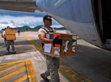 Tech. Sgt. Terrence Wright, an air transportation craftsman, loads a cooler containing units of blood, bound for Kathmandu, Nepal, into a Marine Corps KC-130J Hercules May 10 at U-Tapao Royal Thai Navy Airfield, Thailand.