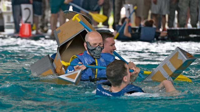 Three participants sink in their collapsing boat. Teams were tasked to bring their own boats to use in the competition, built from only duct tape and cardboard.