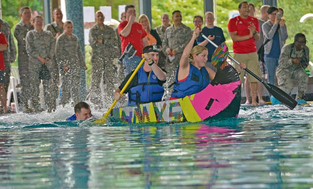 Participants race during the competition. The competition began with boat races, where several handmade boats were pedaled from one end of the center’s pool to the other by the teams who built them.