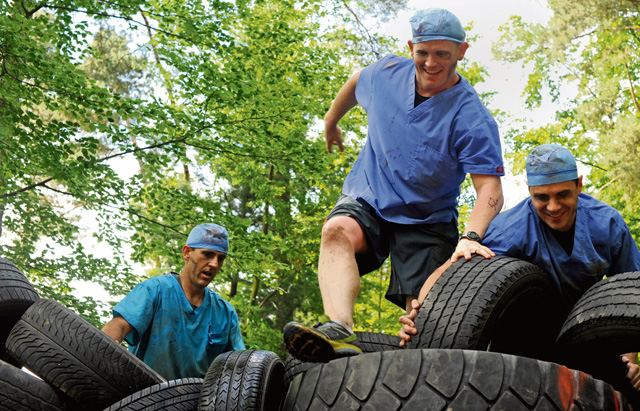 Members of team "Zombie Dentists" climb a tire wall during the Mudless Mudder event June 2 on Ramstein. Mudless Mudder was part of the 86th Airlift Wing's Resilience Day, which gave participants the opportunity to spend time with others and build working relationships.