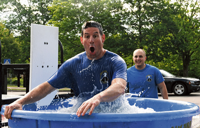 An Airman exits the dunk tank during the Mudless Mudder event.