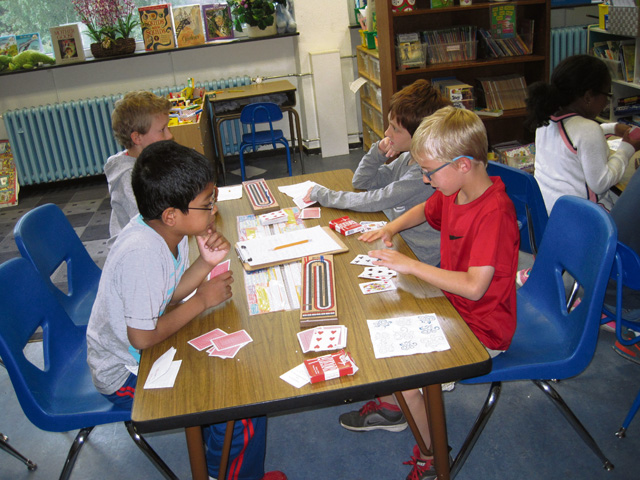 Courtesy photo After-school Cribbage Club (Clockwise from front right) Corbin Porter, Aqeel Jamaldeen, Jacob Barnes, Leo DiPaola and Trinity Payne study Corbin Porter's cards during the second grade after-school Cribbage Club at Vogelweh. The game of cribbage helps the students develop problem-solving, strategy and basic math skills.