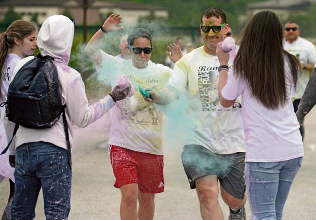 KMC members run through a color station during a color run May 30 on Ramstein. The 5K fun run helped raise funds for the prevention of teen suicide.