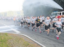 A formation of noncommissioned officers from across the 21st Theater Sustainment Command and U.S. Army Garrison Rheinland-Pfalz run through a barrage of water from a fire hose during a three-mile Army birthday run on Rhine Ordnance Barracks June 12.  More than 500 NCOs from across the area joined together to celebrate the Army’s 240th birthday with the run followed by a cake cutting ceremony.