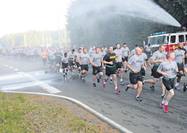 A formation of noncommissioned officers from across the 21st Theater Sustainment Command and U.S. Army Garrison Rheinland-Pfalz run through a barrage of water from a fire hose during a three-mile Army birthday run on Rhine Ordnance Barracks June 12. More than 500 NCOs from across the area joined together to celebrate the Army’s 240th birthday with the run followed by a cake cutting ceremony.