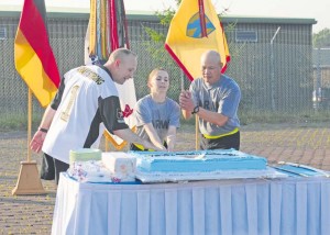 Command Sgt. Maj. Rodney Rhoades (left), the senior enlisted leader of the 21st Theater Sustainment Command, Sgt. Brittney Taylor (center), a behavioral health specialist with the Landstuhl Regional Medical Center and a native of Cleveland, Ohio, and Sgt. Maj. Danilo Diaz (right), the 30th Medical Brigade S4 sergeant major and a native of Roxas City, Philippines, cut the Army birthday cake using an Army saber following the three-mile Army birthday run on Rhine Ordnance Barracks June 12. The morning’s activities brought more than 500 noncommissioned officers from across the 21st TSC and U.S. Army Garrison Rheinland-Pfalz to ROB to build esprit de corps and celebrate the Army’s 240th birthday.