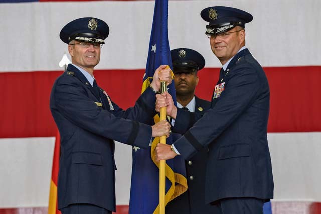 Photo by Senior Airman Nicole Sikorski Brig. Gen. Jon T. Thomas (right), 86th Airlift Wing commander, takes the wing’s guidon from Lt. Gen. Darryl L. Roberson, 3rd Air Force and 17th Expeditionary Air Force commander June 19 on Ramstein. It is military tradition for the guidon to be exchanged between commanders to symbolize the passing of command. 