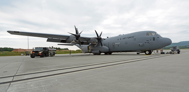 Photo by Airman 1st Class Tryphena Mayhugh A C-130J Super Hercules is prepared for an airdrop training exercise over Kosovo May 27 on Ramstein. The airdrop was a joint exercise between the 37th Airlift Squadron and the 5th Quartermaster Company, Theatre Aerial Delivery Company, to en-hance interoperability.