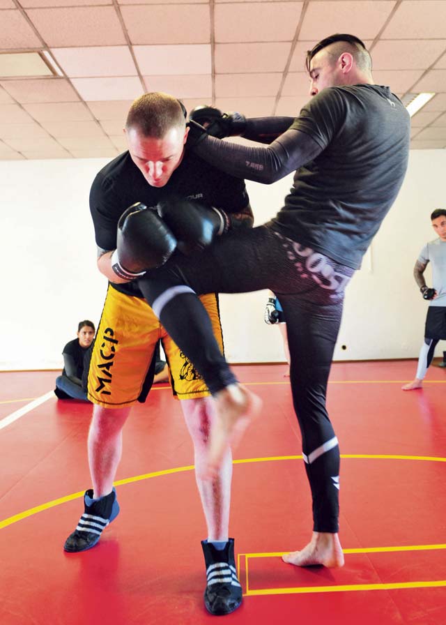  The Outlaw (right), demonstrates how to properly deliver a knee strike on Staff Sgt. David Maybury, 7th Civil Support Command, 21st Theater Sustainment Command master combatives trainer. 