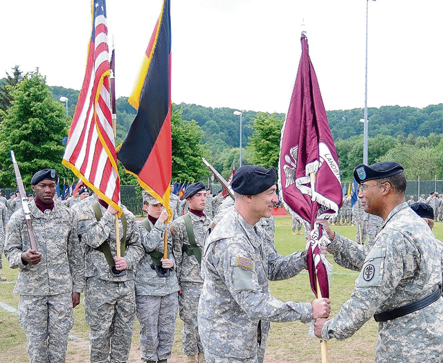 Photo by Phil A. Jones Brig. Gen. Norvell V. Coots (right), Commander for Europe Regional Medical Command and the Command Surgeon for U.S. Army Europe, passes the colors to Col. James Laterza signifying him as the new commander for Landstuhl Regional Medical Center during a change of command ceremony May 29. 