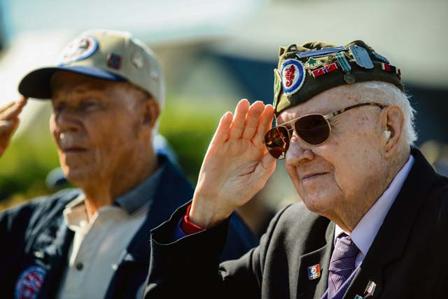 A World War II veteran salutes during "The Star-Spangled Banner" during a ceremony at the Picauville 9th Air Force monument June 4 in Normandy, France. More than 380 service members from Europe and affiliated D-Day historical units participated in the 71st Anniversary as part of Joint Task Force D-Day 71.