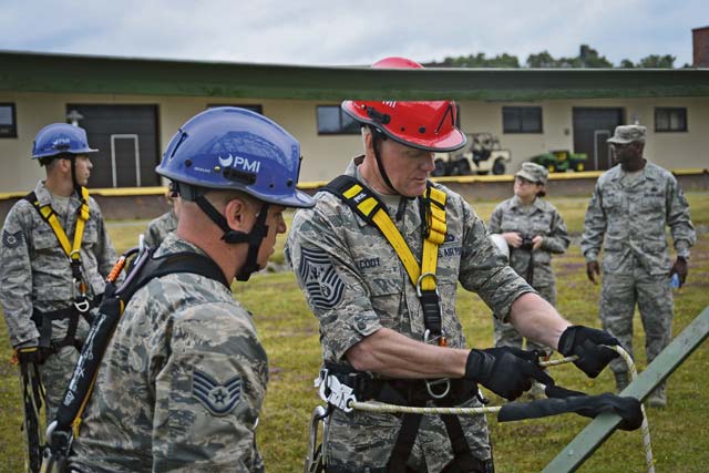 Staff Sgt. Daniel Peters, 1st Communications Maintenance Squadron cable and antenna theater maintenance supervisor, assists Chief Master Sgt. of the Air Force James A. Cody with safely donning his climbing harness June 22 on Ramstein. Cody performed a tower climb with Airmen from the 1st CMXS during his 435th Air Ground Operations Wing immersion tour. 