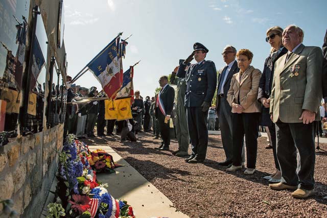 Allied leaders salute the memorial of fallen U.S. service members.
