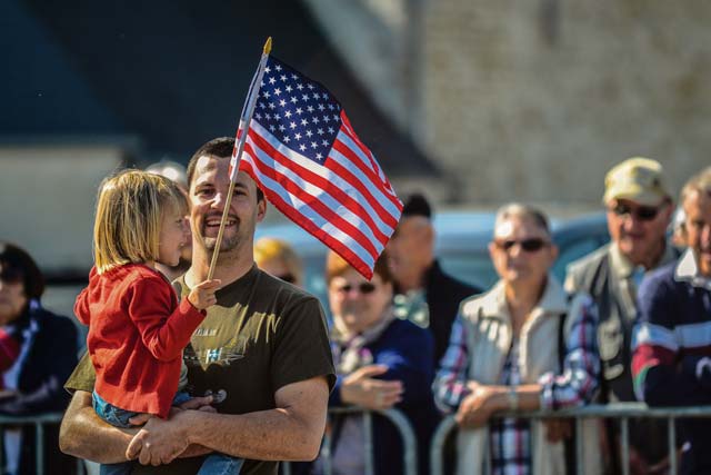 A father holds his daughter during the memorial ceremony.
