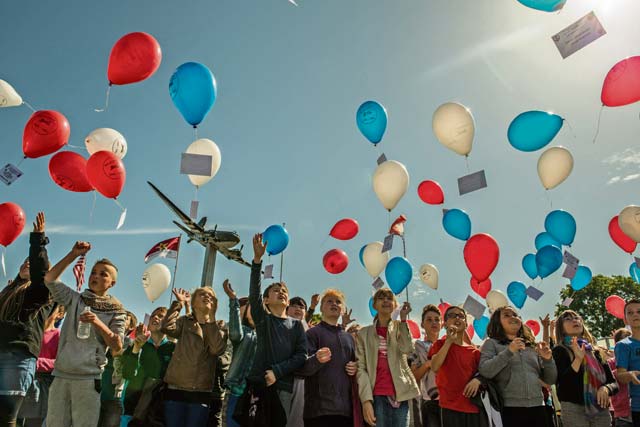 French children let balloons soar into the sky to celebrate the service of the U.S. military during D-Day.