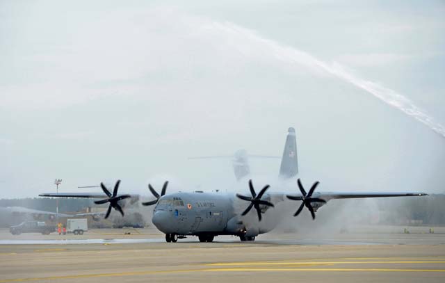Mordente taxis a C-130J Super Hercules as the aircraft gets sprayed down by firetrucks. Mordente, along with several aircrew members from the 37th Airlift Squadron, took his four-hour final flight over Germany on the anniversary of his pilot training graduation date 27 years ago.