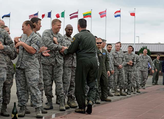 Mordente shakes hands with Airmen down a receiving line after his final flight. Mordente entered the Air Force in 1987 as a graduate of the U.S. Air Force Academy and earned his pilot wings in 1988.