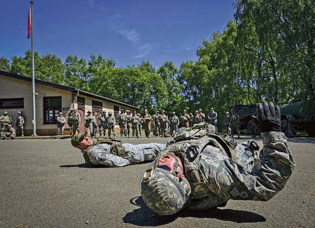 Master Sgt. Timothy Bertrand, 86th Security Forces Squadron NCO in charge of physical security, conducts flutter kicks during live-fire, stress-fire training June 18 on Baumholder. 