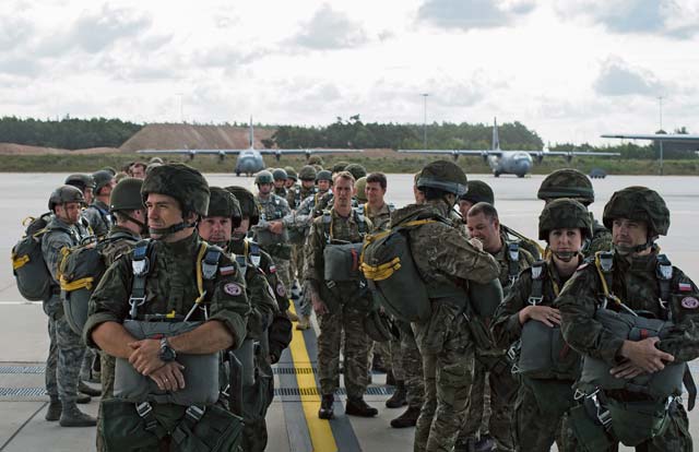 Photo by Senior Airman Damon Kasberg  Paratroopers wait to enter a C-130J Super Hercules during International Jump Week  July 8 on Ramstein. Service members throughout Europe and as far away as New Zealand traveled to Germany for the five-day event. Every year to culminate the jump training, paratroopers from the allied countries gather for a wing exchange, where they exchange jump wings from fellow paratroopers, signifying the bonds built.