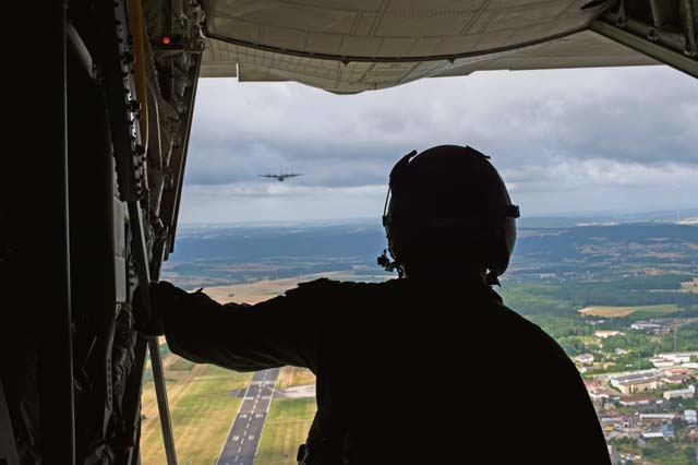 Photo by Senior Airman Damon Kasberg  Airman 1st Class Austin Lilly, 37th Airlift Squadron loadmaster, looks out the back of a C-130J Super Hercules ensuring paratroopers can safely exit the aircraft during International Jump Week July 8 on Ramstein. International Jump Week is an annual event giving paratroopers the opportunity to practice high altitude, low-opening and static-line jumps. Pilots, loadmasters and parachute riggers were also able to train during the week.