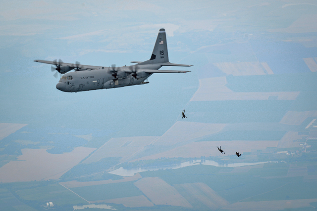 U.S. and Bulgarian paratroopers jump from an 86th Airlift Wing C-130J Super Hercules during a Halo jump over Plovdiv, Bulgaria, July 14. During this three-hourlong formation flight that consisted of two U.S. Air Force C-130Js and one Bulgarian air force C-27, more than 50 paratroopers exited the aircraft and landed near Plovdiv Airport.