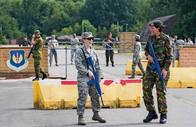 U.S. Air Force Maj. Frances Dixon, 439th Aircraft Maintenance Squadron operations officer (left), speaks with Dutch army 1st Lt. Abeltje Tromp, 20th Natresbat platoon leader, while guarding an entry control point during the International Junior Officer Leadership Development Course July 22 on Ramstein. IJOLD is a multinational seminar designed to promote international military understanding and friendship. Students participated in various individual and group activities, all in the spirit of developing one's leadership skills.