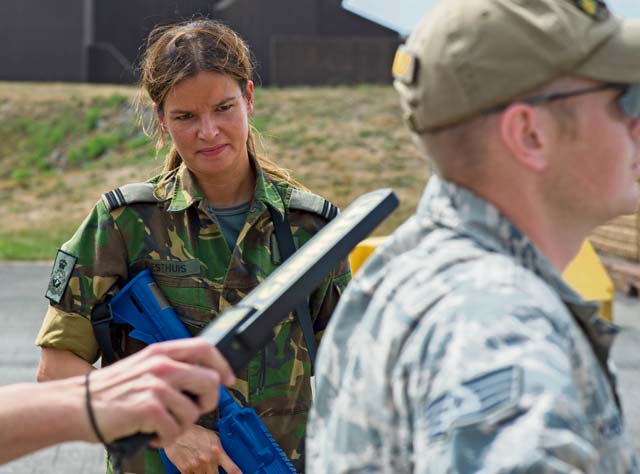 Dutch army 1st Lt. Sandra Riesthus, human factors officer, watches a body check at an entry control point. 