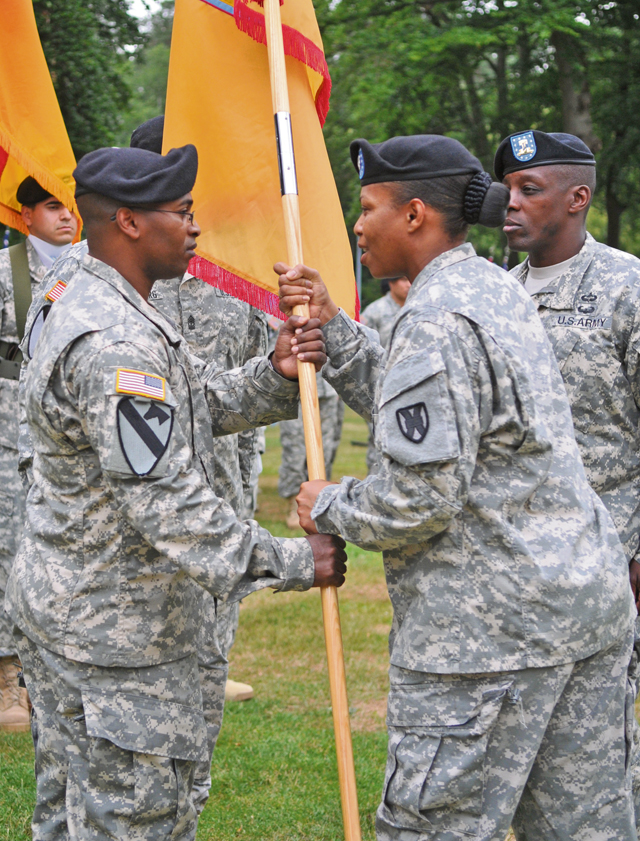 Lt. Col. Caprissa Brown-Slade, commander of the Special Troops Battalion, 21st Theater Sustainment Command, passes the guidon to Command Sgt. Maj. Anthony Williams during a change of responsibility ceremony July 14 on Panzer Kaserne. Williams is replacing Command Sgt. Maj. Brian Mainor as the command sergeant major of the STB.