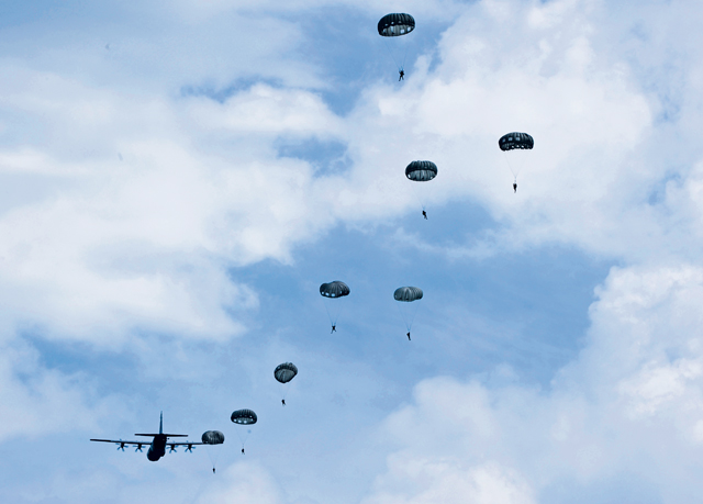 Photo by Staff Sgt. Leslie Keopka Paratroopers exit a C-130J Super Hercules during International Jump Week near Alzey, Germany, July 7. During jump week, more than 200 U.S. and allied partners disembarked their designated airframes to strengthen skills and tactics while building and strengthening international relations with counterparts.