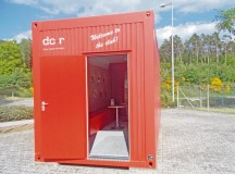 The Documentation and Exhibition Centre, a permanent exhibition, in bright red shipping containers.