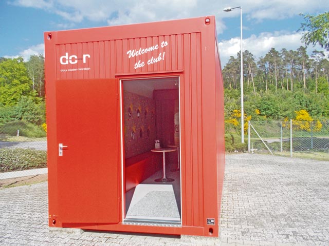 The Documentation and Exhibition Centre, a permanent exhibition, in bright red shipping containers.