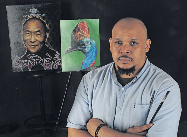 Kevin Lewis, 86th Force Support Squadron program coordinator, poses with his artwork June 29 on Ramstein.