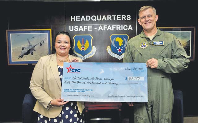 Victoria Adams, Combined Federal Campaign-Overseas executive director, presents a check on June 23 to Gen. Frank Gorenc, U.S. Air Forces in Europe and Air Forces Africa commander, for funds raised last year.