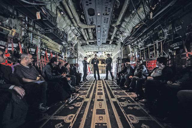 Capts. Jonathan Recor and Sean McKee, C-130J Super Hercules pilots assigned to the 37th Airlift Squadron, brief German local nationals before the orientation flight. Recor and McKee briefed safety procedures and what to do in case of flight sickness.