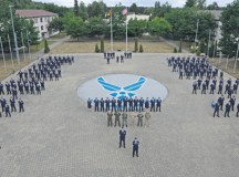 Airmen from the NCO Academy form together before performing a retreat ceremony July 9 at Kapaun, Germany. Retreat serves as a reminder to pay respect to the flag in addition to signaling the end of the official duty day.