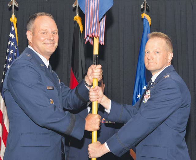 Photo by Staff Sgt. Sharida Jackson Col. Brent Johnson (right), accepts the 86th Medical Group's guidon from 86th Airlift Wing Commander Brig. Gen. Jon Thomas (left), during the 86th MG's change of command ceremony June 30.