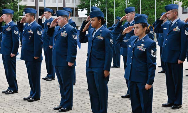 NCO Academy Airmen salute during a retreat ceremony July 9. Since 1947, the birth year of the U.S. Air Force, Airmen have performed retreat ceremonies at the end of every official duty day. 