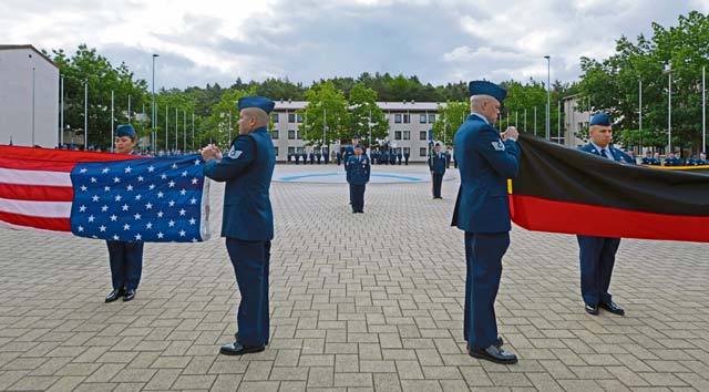 NCO Academy Airmen fold the U.S. and German flag during a retreat ceremony July 9. The lowering of the flag is a tradition signifying the end of the official duty day.