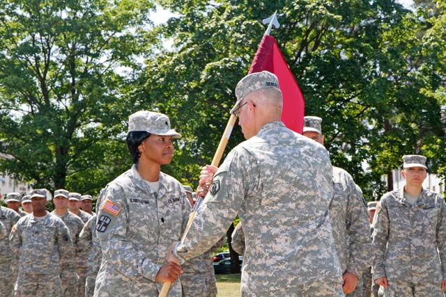 Photo by Lt. Col. Jefferson Wolfe Army Lt. Col. Bidemi Y. Olaniyi-Leyimu (left), Medical Support Unit-Europe incoming commander, receives the unit guidon from Brig. Gen. Arlan M. DeBlieck, commander of the 7th Civil Support Command, during a ceremony held July 11 on the Daenner Kaserne parade field. The passing of the guidon is a tradition symbolizing the changing of command.