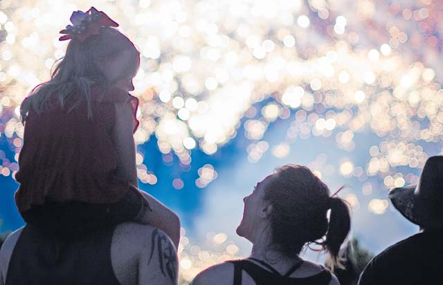 A family watches fireworks during Freedom Fest. The two-day event was held in celebration of the United States’ Independence Day. On the final day, attendees were able to enjoy a fireworks show.