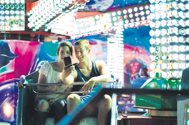 Attendees of Freedom Fest pose for a photograph while on an amusement ride July 4 on Ramstein. The two-day event was held in celebration of the United States’ Independence Day. Attendees were able to enjoy rides, food, fireworks and live concerts.