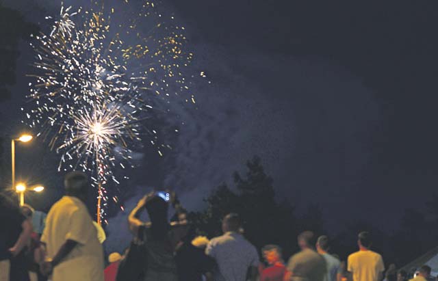 Patrons of Freedom Fest watch a fireworks show.
