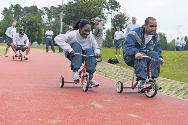 Photo by Tech. Sgt. Daylena S. Ricks Tricycle riders catch up to their partners at the tricycle relay race during Resilience Day Sept. 11, 2014 on Ramstein. This year's Resilience Day featured a Commander's Challenge compiled of athletic events to challenge Airmen.