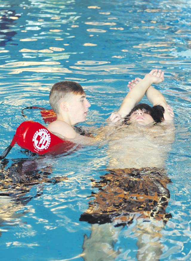 Spencer Clementz (left) rescues a simulated victim during a lifeguard course Aug. 13 on Ramstein. Participants in the course practiced active and passive drowning victim rescue as well as CPR and first aid.