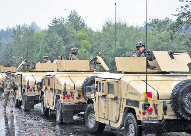Soldiers from the 18th Military Police Brigade pull security as part of a convoy during Rapid Trident 15 at the International Peacekeeping and Security Center July 29. Rapid Trident 15 is part of U.S. European Command's Joint Exercise Program and designed to enhance joint combined interoperability with allied and partner nations.
