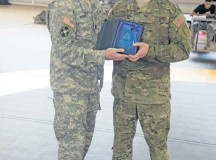 Army Sgt. Maj. James Murrin, senior enlisted leader of the 7th Civil Support Command, presents the cruiserweight trophy to Air Force Staff Sgt. Joseph B. Everett of the 86th Aircraft Maintenance Squadron, during the 7th Civil Support Command's Inaugural Combatives Tournament Aug. 14.