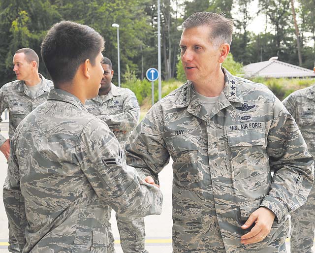 Photo by Airman 1st Class Larissa Greatwood Lt. Gen. Timothy M. Ray, 3rd Air Force commander, coins Airman 1st Class Justin Hernandez, 86th Aircraft Maintenance Squadron aerospace maintenance craftsman, during his 86th Airlift Wing immersion tour.