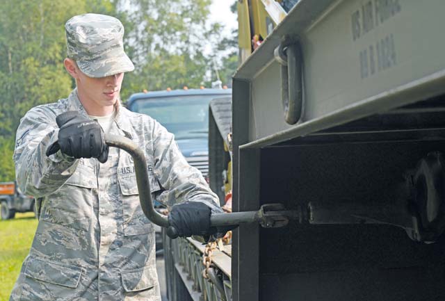 Airman 1st Class Richard Zeren, 786th Civil Engineer Squadron heavy equipment operator, turns a crank to prepare a tractor trailer vehicle from disengaging from a hitch to a flatbed during the Air Force Civil Engineer Center Tractor Trailer Training program  Aug. 10 on Ramstein. This is the first time this program is being taught in U.S. Air Forces in Europe.