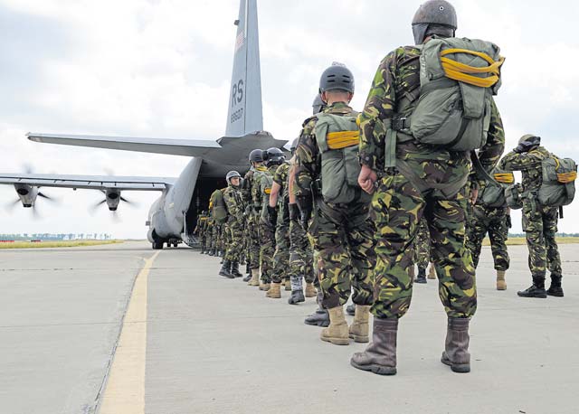 Romanian paratroopers wait to board an 86th Airlift Wing C-130J Super Hercules Aug. 18 at Boboc Air Base, Romania. Romanian paratroopers practiced both freefall and static line airborne operations as part of exercise Carpathian Summer, a bilateral training event designed to increase readiness and interoperability between the U.S. Air Force and the Romanian air force.