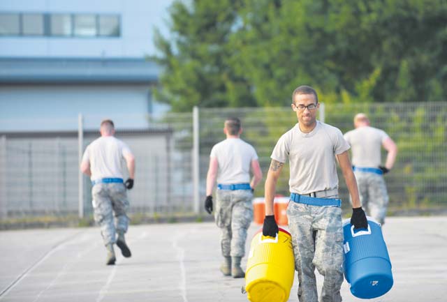 Staff Sgt. Ryan Evans, 721st Aerial Port Squadron passenger services specialist, carries water jugs during the obstacle course at the 2015 Ramstein Air Base Rodeo Aug. 1 on Ramstein. The rodeo is a skills competition and includes numerous events such as forklift operations, center of balance calculations and cargo pallet buildup.